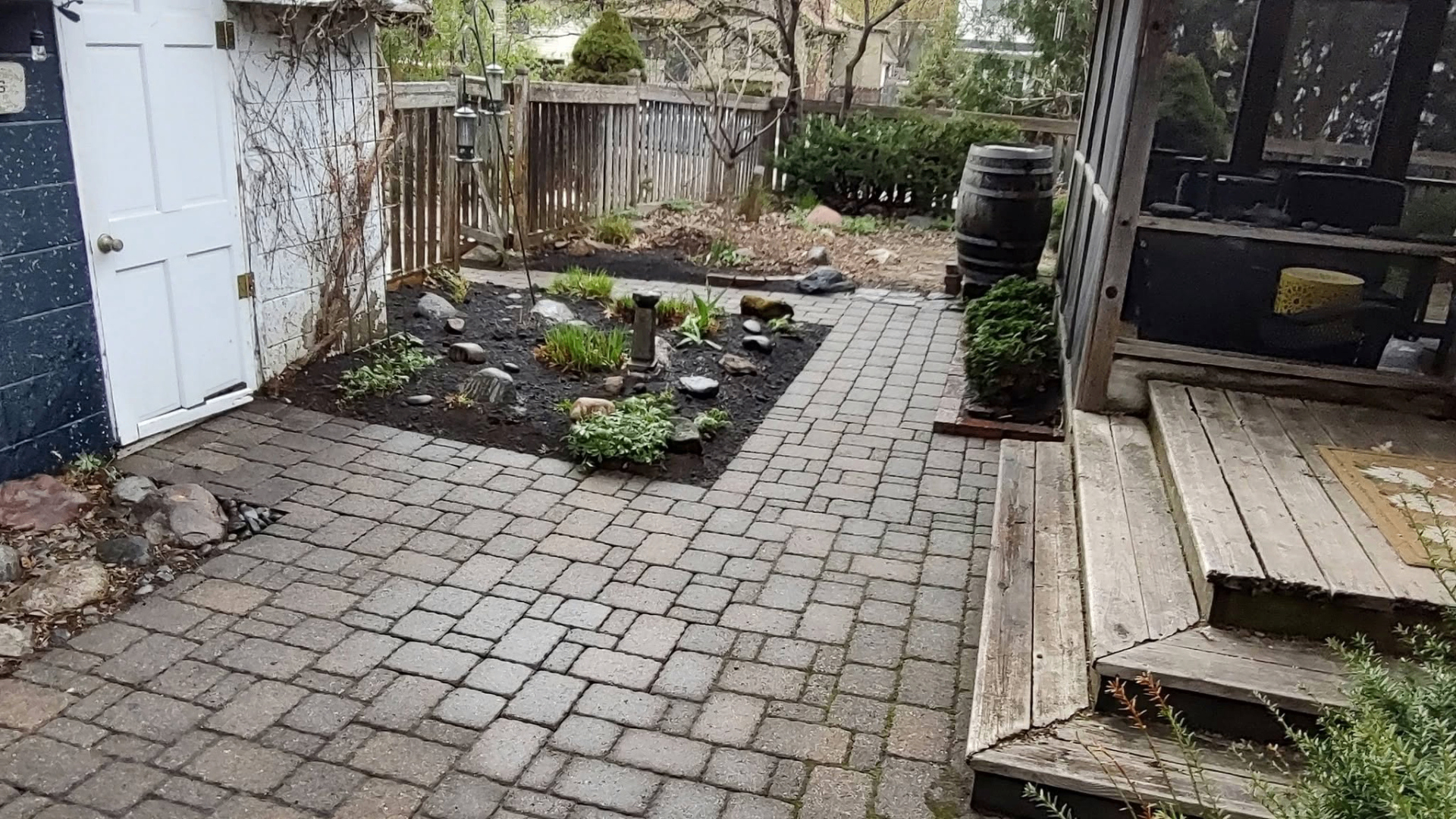 Interlocking paver patio with garden bed